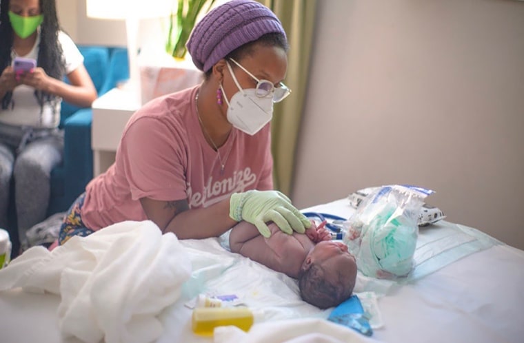 Jamarah Amani caring for a newborn