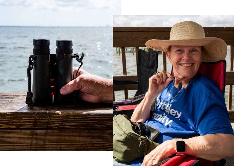 Pat Dimond seated on the dock at Space View Park in anticipation for the the Artemis II launch on Tuesday. She is holding a wedding band worn in memory of her husband.