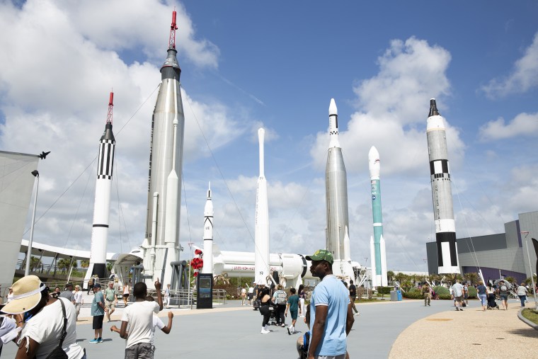 People gather at Kennedy Space Center Visitor Complex in Merritt Island, Fla., on Tuesday.