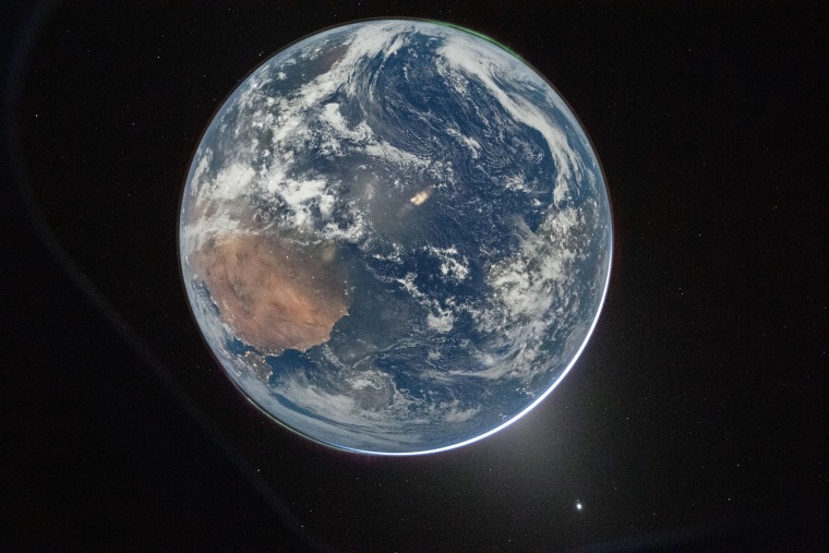 Earth from nan Orion spacecraft’s model aft completing nan translunar injection burn.