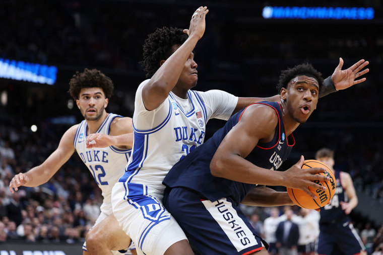 UConn's Tarris Reed drives around Patrick Ngongba of the Duke Blue Devils on March 29, 2026.