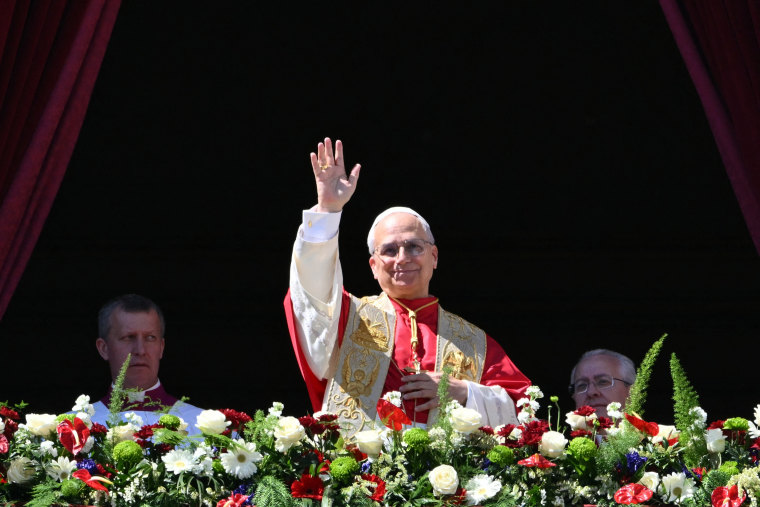 Pope Leo XIV waves to the crowd from the main balcony of St. Peter's Basilica for the Urbi et Orbi message and blessing to the city and the world as part of Easter celebrations on April 5.