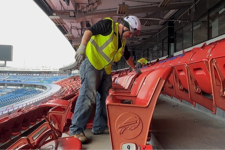 Construction workers take apart parts of Highmark Stadium.