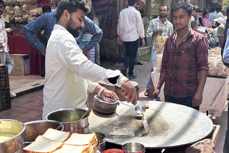 Vinay Chauhan prepares his stall in Chandni Chowk, Delhi, on Friday