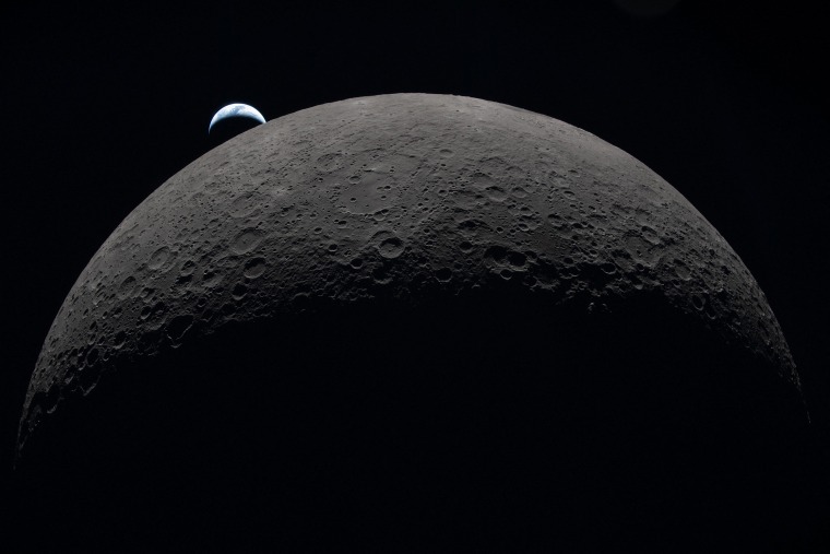 A crescent Earth setting along the Moon's limb