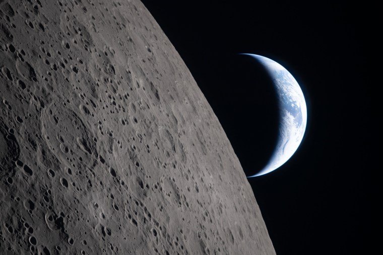 A crescent Earth setting along the Moon's limb