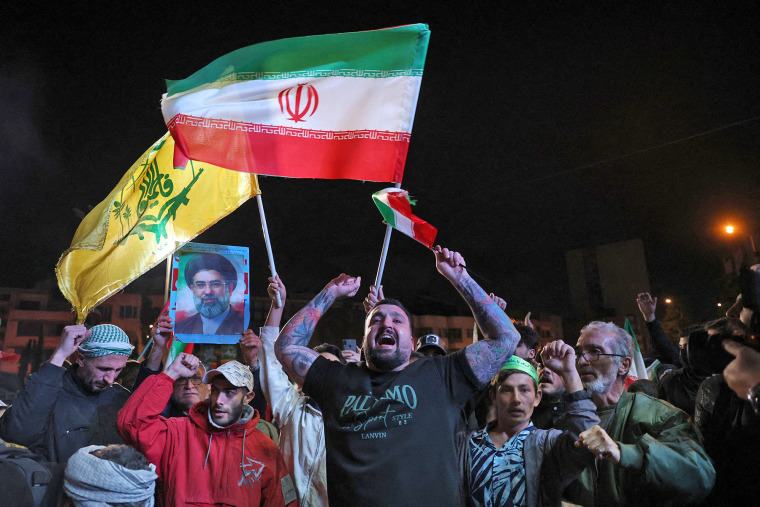 Iranians react to news of a ceasefire announcement at Enqelab Square in Tehran, on April 8 2026. 
