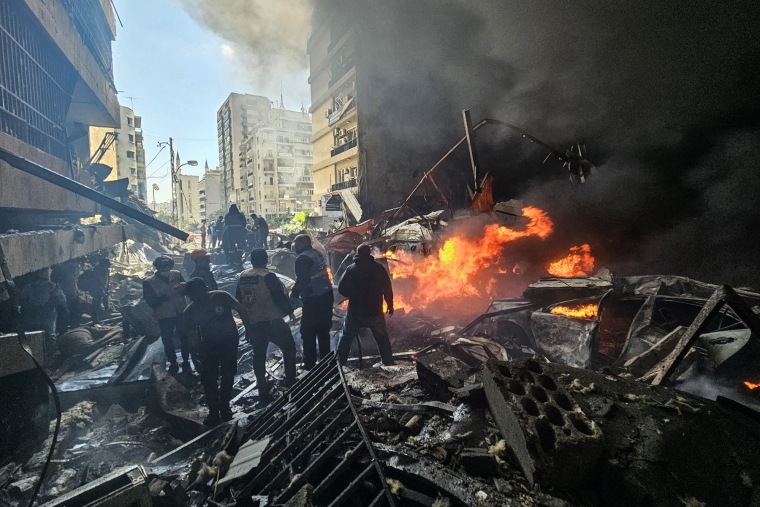 First responders stand amid rubble at the site of an Israeli airstrike in Beirut's Corniche al-Mazraa neighborhood on April 8, 2026. 
