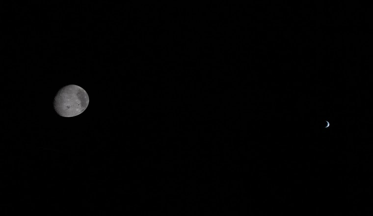 The moon and Earth each partially illuminated by the sun as seen from the Orion spacecraft on April 6, 2026. 