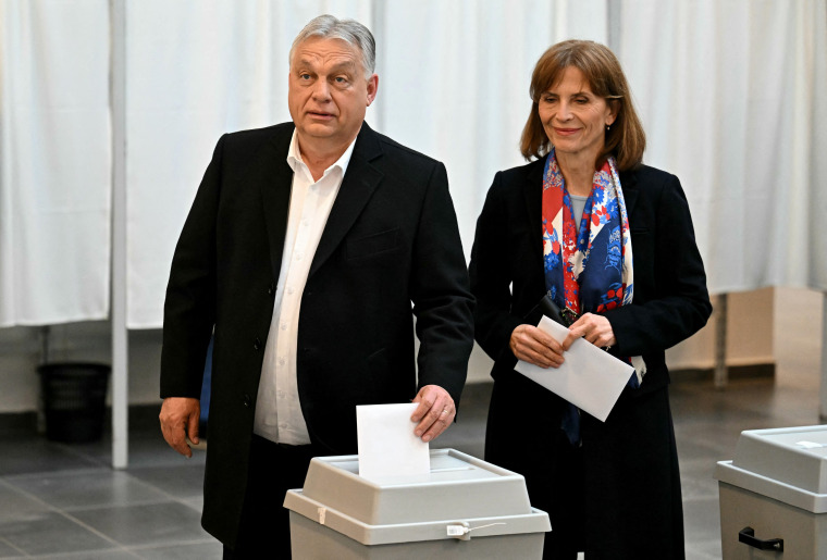 Hungary's nationalist Prime Minister Viktor Orban of the Fidesz party stands next to his wife Aniko Levai as he casts his ballot at a polling station in Budapest during a general election on April 12.