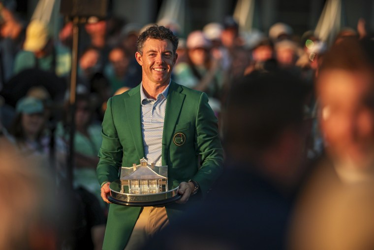 Image: Rory McIlroy of Northern Ireland reacts with the Masters Trophy during the Green Jacket Ceremony
