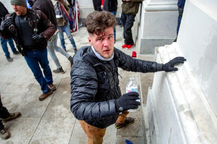 David Paul Daniel holds a water bottle while standing at the U.S. Capitol building