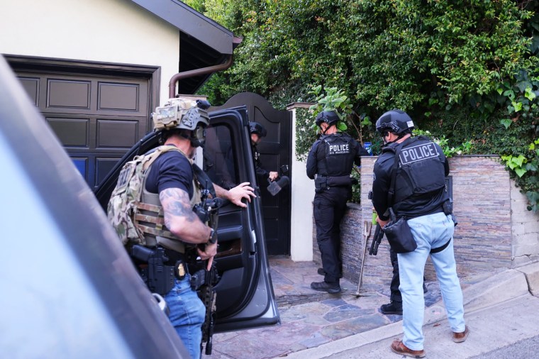 An image shared on X by Los Angeles Police Department shows officials prior to D4vd's arrest.