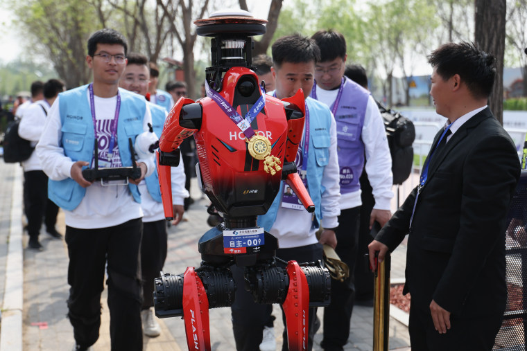 Winner The "Blitz" robot from smartphone manufacturer Honor accept media interviews after the 2026 Beijing E-Town Humanoid Robot Half-marathon on April 19.