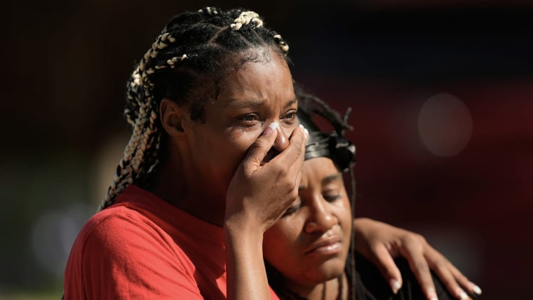 People grieve as they comfort each other outside the scene of a mass shooting in Shreveport, La., April 19, 2026.