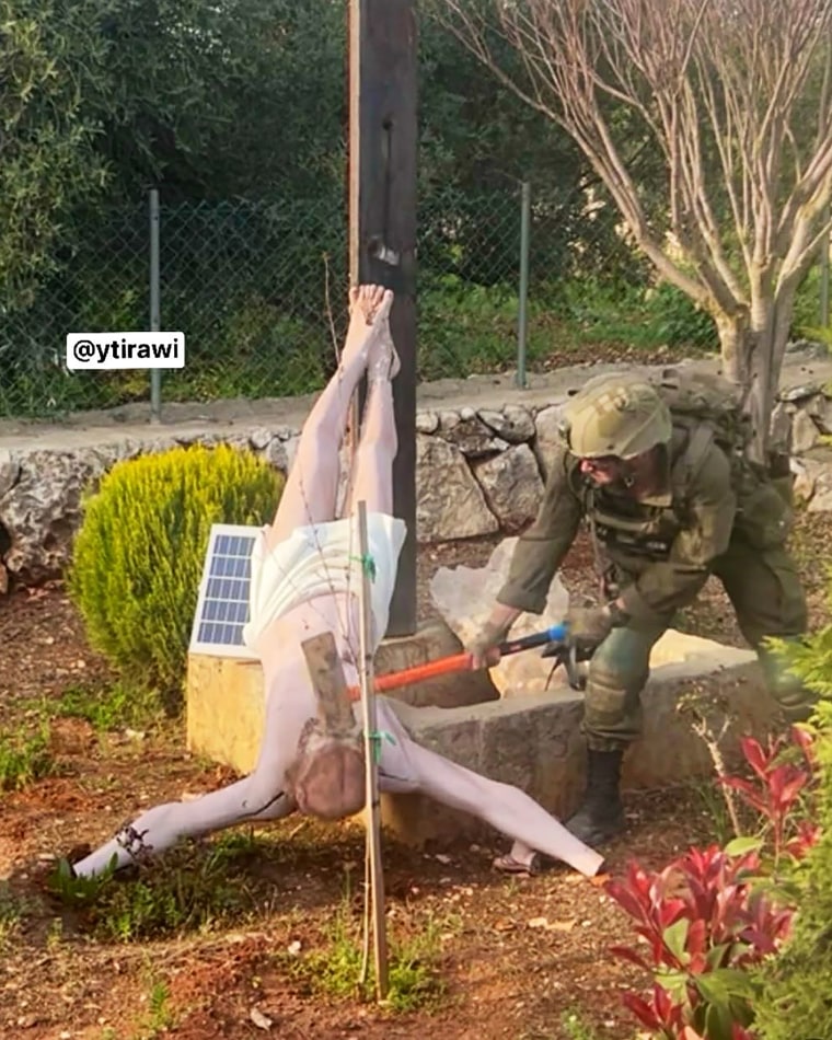 An IDF soldier damaging a Jesus statue in southern Lebanon, in a photo shared on social media on Apr. 19.