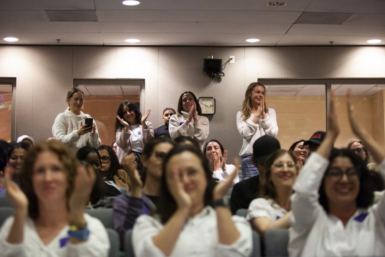 Supporters of screen time limits cheer during a Los Angeles school board meeting.