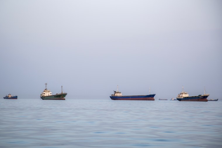 Ships are anchored near the shoreline  in Bandar Abbas, Iran.