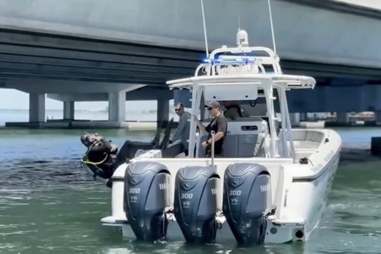 Members of the Hillsborough County Sheriff’s Office marine and dive teams search the area around the Howard Frankland Bridge in Tampa, Florida, on Friday.