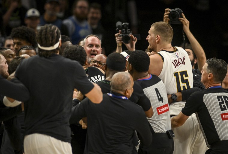 Nikola Jokic of the Denver Nuggets and Julius Randle of the Minnesota Timberwolves engage in a melee