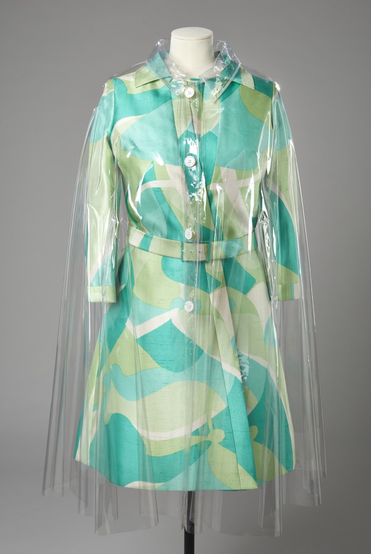 Transparent raincoat, Hardy Amies, 1960s. Worn over a patterned silk day dress and coat, Hardy Amies, 1970s.