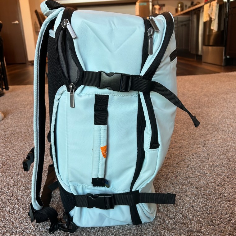 The buckled straps help compress the Open Story carry-on backpack so it can easily fit in an overhead bin.