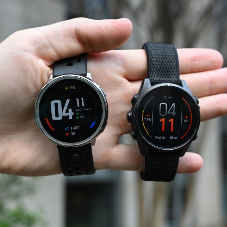 The Amazfit Active 2 and Garmin Fenix 8 in the hand of the writer.