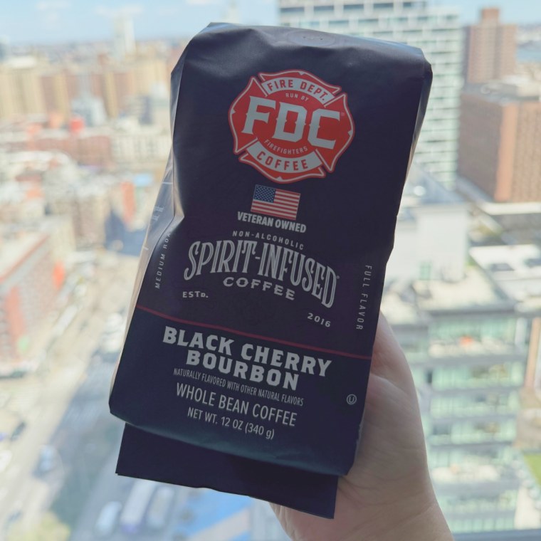 Fire Dept. Coffee Beans in front of a window with a city view.