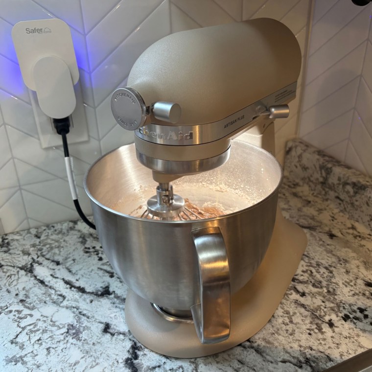 A KitchenAid Artisan Plus 5-Quart Tilt-Head Stand Mixer making frosting.