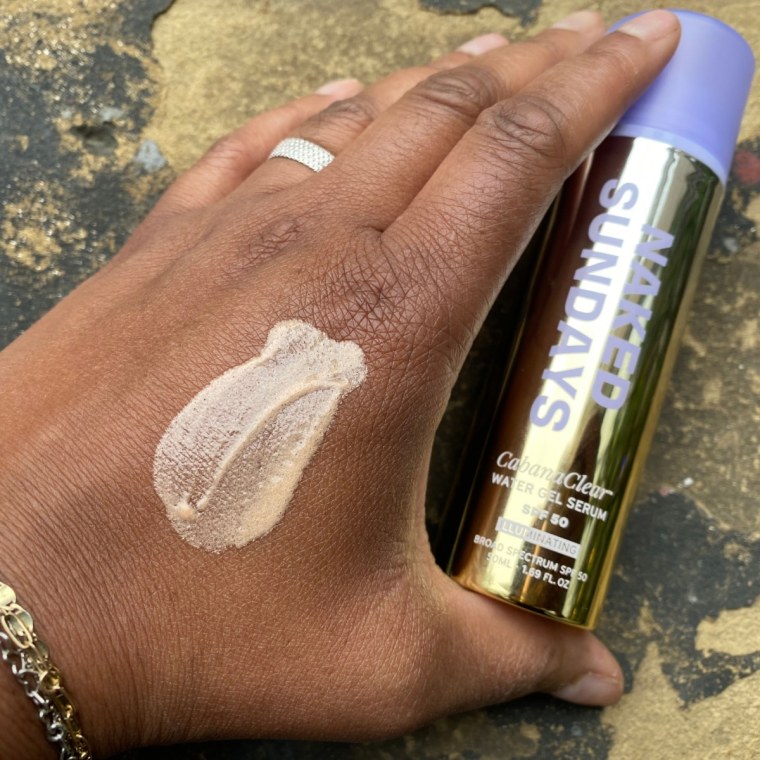 Woman with swatch of sunscreen on hand