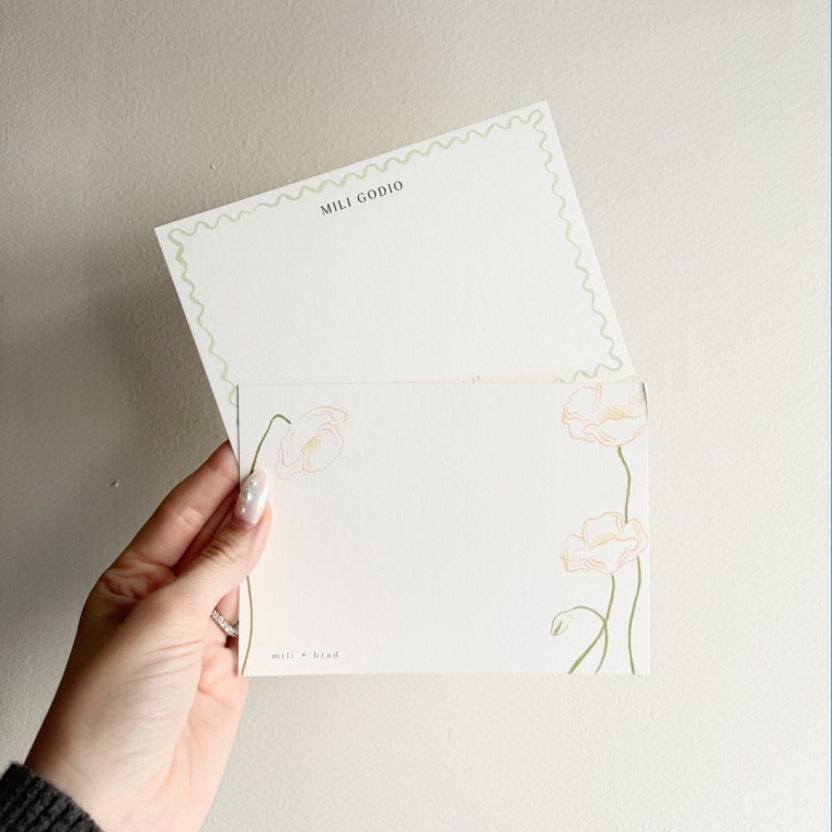 Woman holding up two note cards