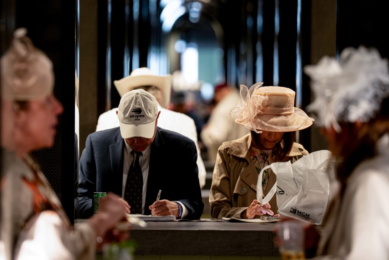 Attendees look at betting books.