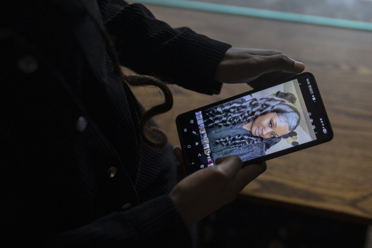 Estafania Andre, who holds a photo of her sister Olivia, shouted Olivia's name every day while she was in detention at Dilley in hope of locating her.