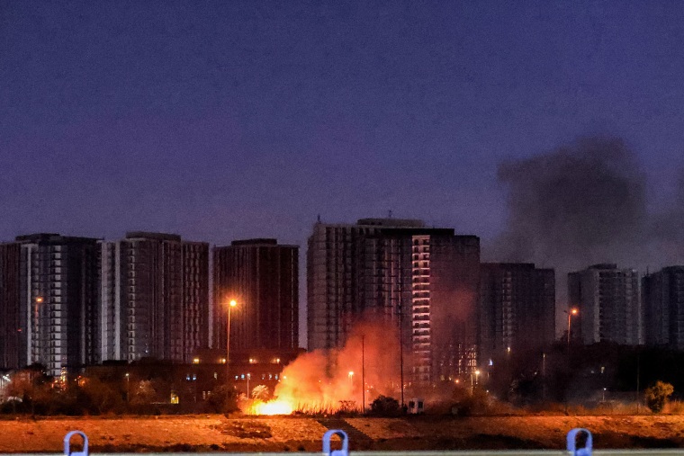 A fire burns outside the grounds of the U.S. Embassy in Baghdad