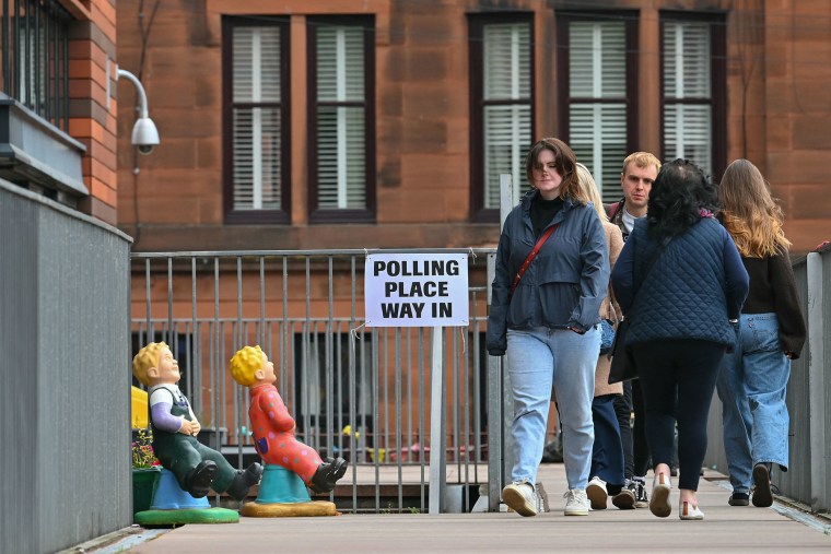 Voters leave a polling station at a primary school in west Glasgow, Scotland on May 7, 2026.