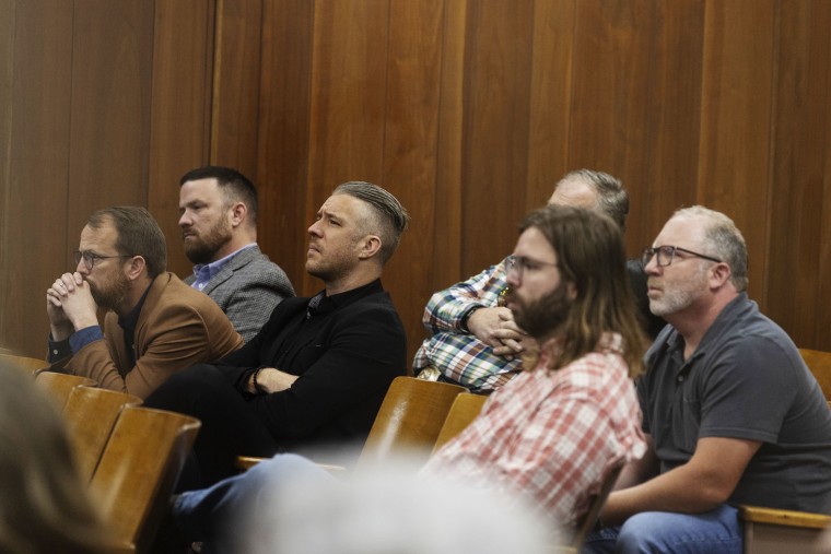From left, Krys Scroggins, Joseph Cleveland, Danny Clark, and far right, Ron Bloomingkemper, listen as Daniel Savala is sentenced.