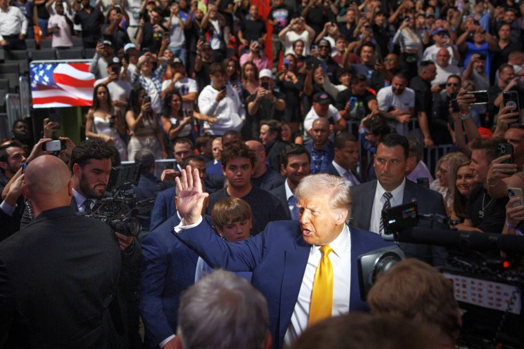 President Donald Trump waves to a cheering crowd.