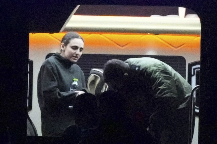 Israeli Romi Gonen, who was kidnapped in Gaza by Hamas on Oct. 7, 2023, steps out of a van after being released in southern Israel on Jan. 19, 2025.