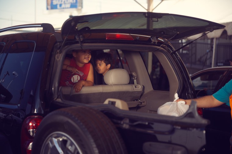 Volunteers loaded food into one of the waiting cars at St. Mary’s Food Bank in Phoenix on April 29.