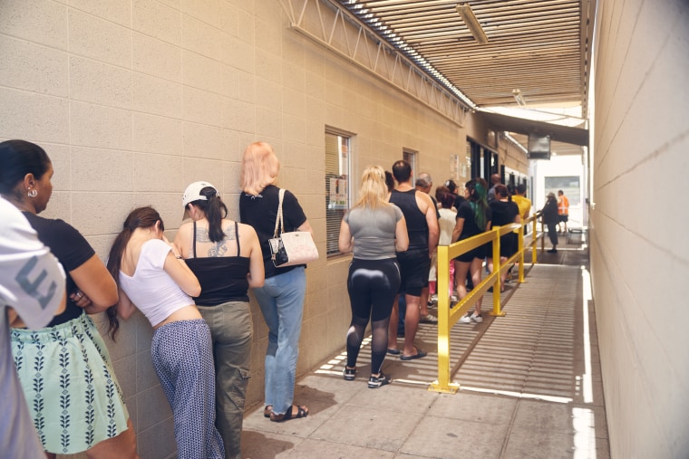 People wait in line at St. Mary’s Food Bank