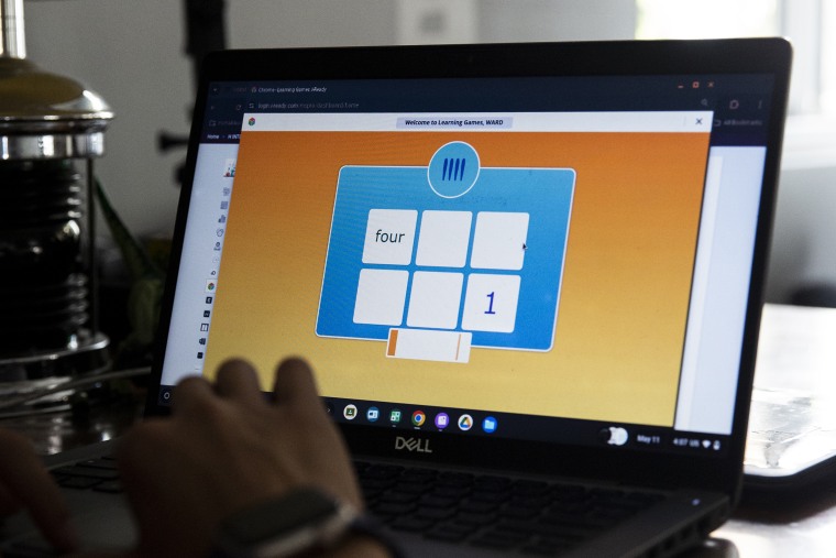 Ward shows how an i-Ready game works on his school-issued Chromebook.