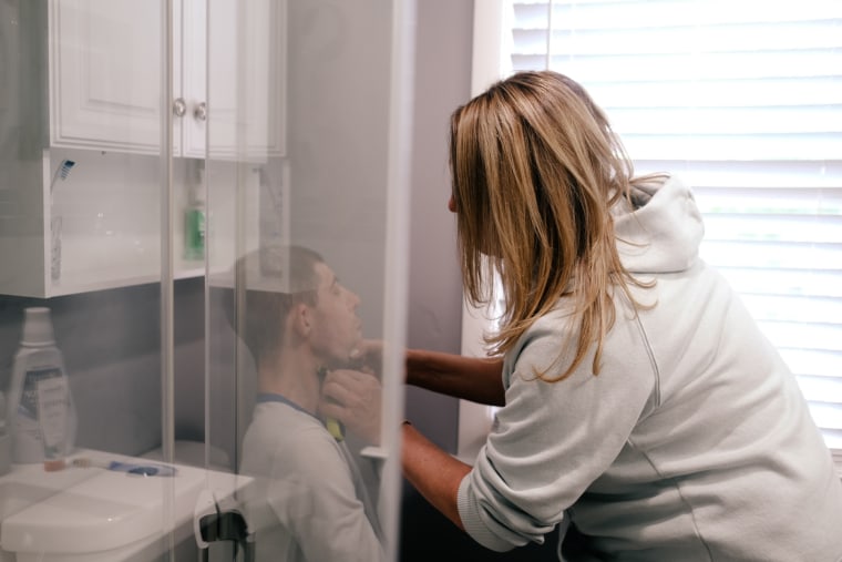 Melissa Gonce shaves Jason's chin in their bathroom