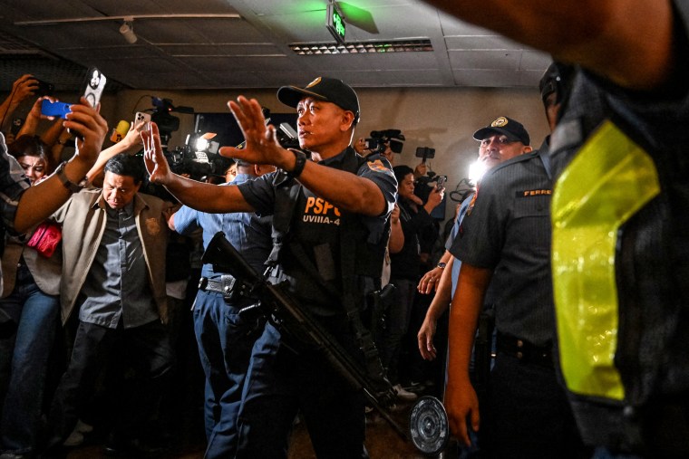 Police personnel arrive as people react to the gunshots heard inside the Senate of the Philippines.