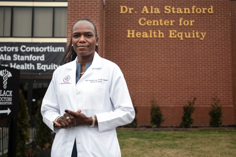 Ala Stanford stands outside in front of the Dr. Ala Stanford Center for Health Equity building