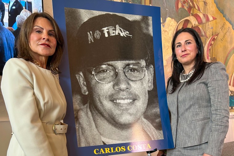 Mirta Costa Méndez stands next to the image of her late brother, Carlos Costa, one of the men killed in the shoot down of the Brothers to the Rescue planes in 1996. Melisa Chantres, on the right, is his niece.