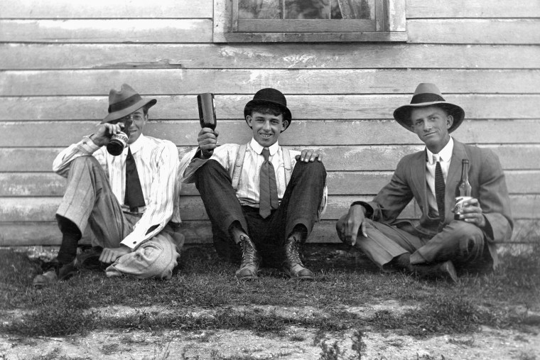 Three apparently happy men enjoy their Schlitz beer, ca. 1920