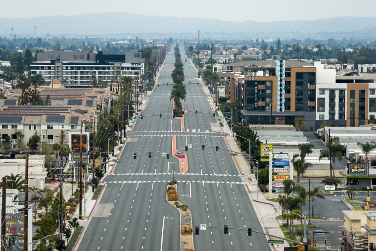 An eight lane highway devoid of any traffic in California, seen from the air.