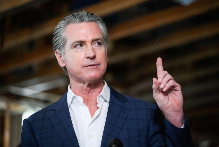 Governor Newsom speaks while pointing his finger upwards