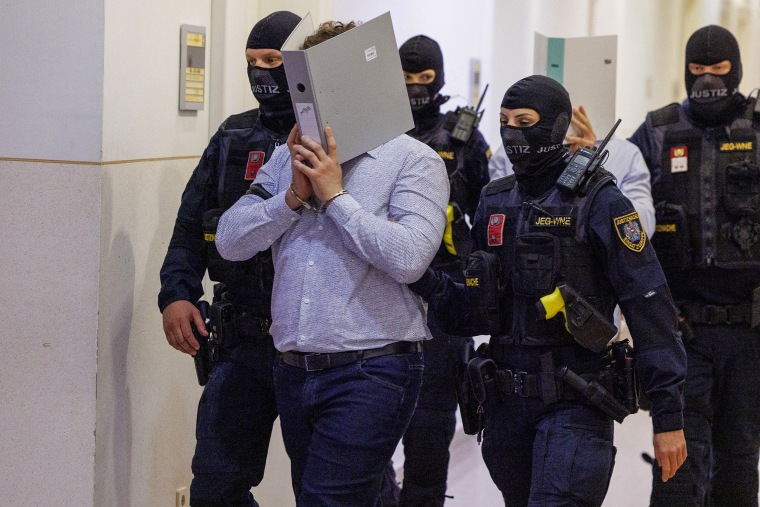 A defendant in handcuffs.