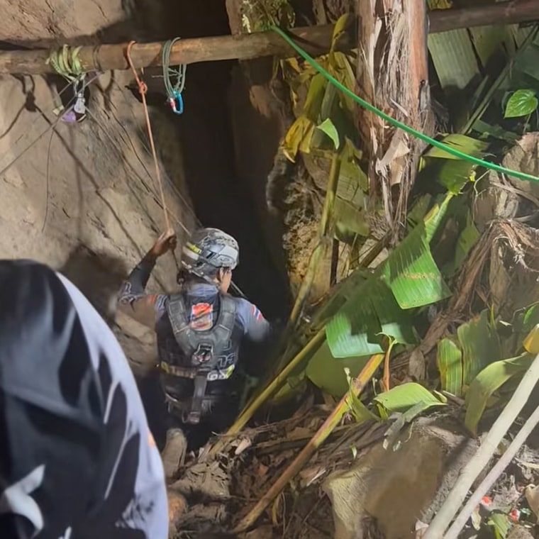 A rescuer works to evacuate people trapped in a cave in Laos.